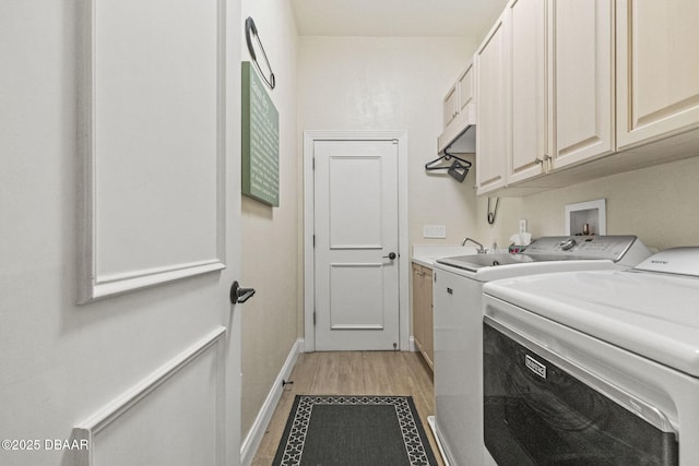 1207 Kaleen Dr, Ormond Beach, FL 32174 - laundry room with cabinet space, independent washer and dryer, and light wood-type flooring