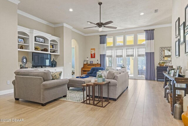 1207 Kaleen Dr, Ormond Beach, FL 32174 - living room with arched walkways, light wood-style flooring, a ceiling fan, recessed lighting, and crown molding
