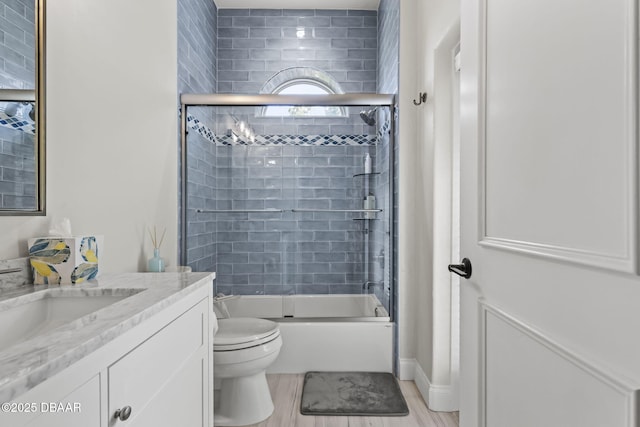 1207 Kaleen Dr, Ormond Beach, FL 32174 - full bath featuring vanity, shower / bath combination with glass door, and wood finished floors