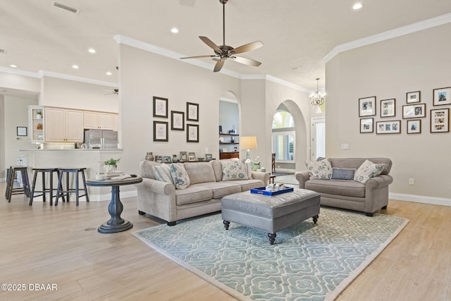 1207 Kaleen Dr, Ormond Beach, FL 32174 - living room with arched walkways, a ceiling fan, light wood-style flooring, crown molding, and recessed lighting