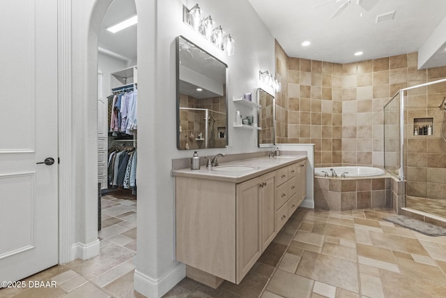 1207 Kaleen Dr, Ormond Beach, FL 32174 - full bath featuring a stall shower, double vanity, a garden tub, a walk in closet, and recessed lighting