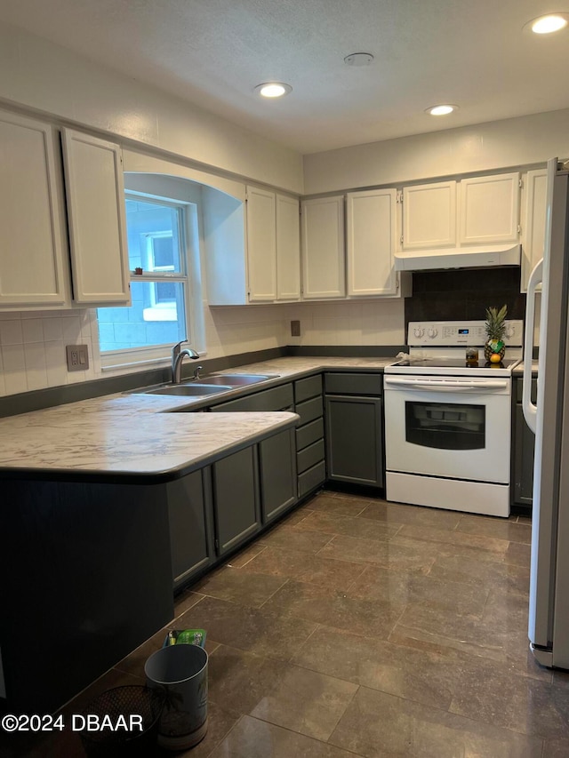 kitchen featuring sink, backsplash, white appliances, white cabinets, and gray cabinetry