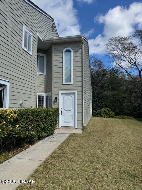 doorway to property featuring a yard