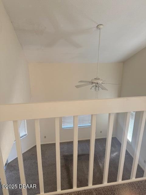 staircase with ceiling fan and carpet flooring