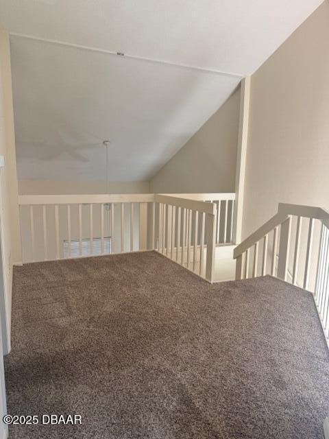 interior space with lofted ceiling and carpet flooring