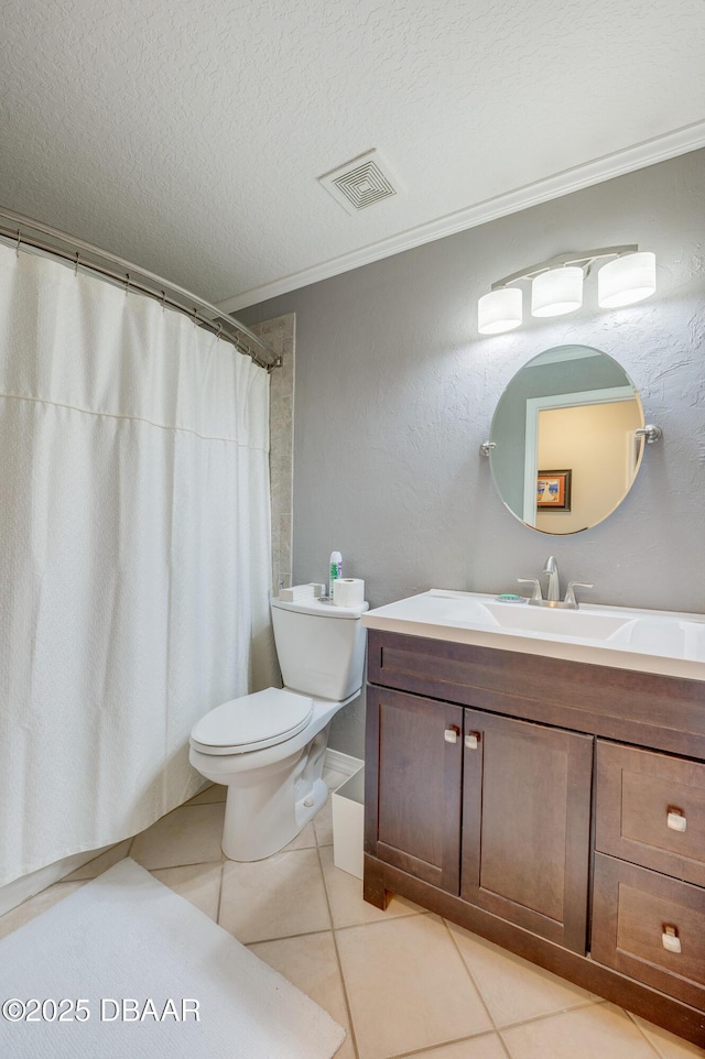 bathroom featuring toilet, vanity, tile patterned flooring, crown molding, and a textured ceiling