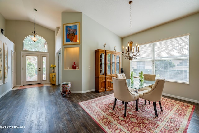 dining area with dark wood-type flooring, a chandelier, and high vaulted ceiling