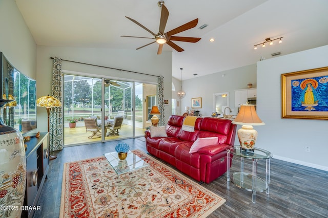 living room with ceiling fan, sink, dark hardwood / wood-style flooring, and lofted ceiling