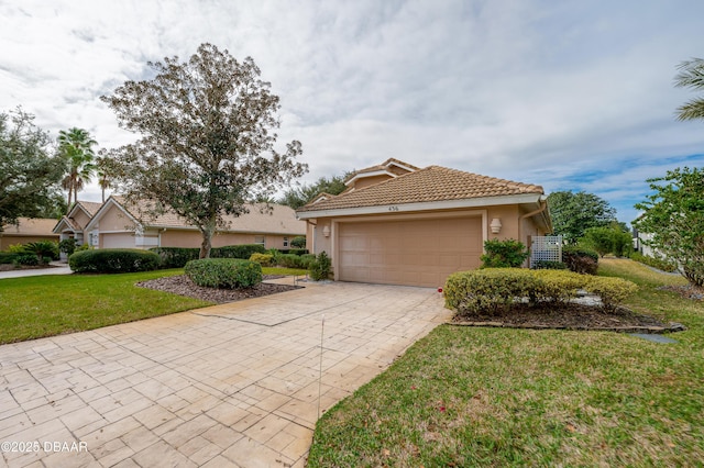 view of front of house with a front yard and a garage