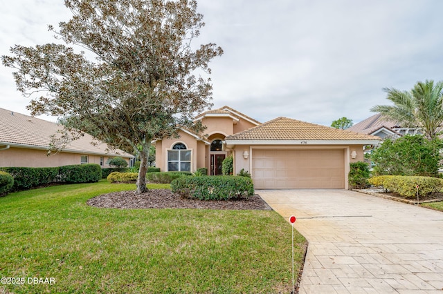 mediterranean / spanish home with a front yard and a garage