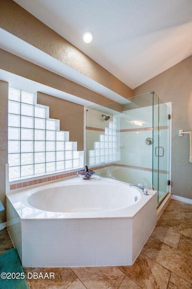 bathroom featuring shower with separate bathtub