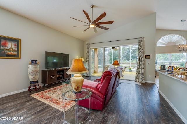 living room featuring plenty of natural light, dark hardwood / wood-style floors, and a notable chandelier