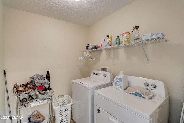 laundry area featuring independent washer and dryer and a textured ceiling