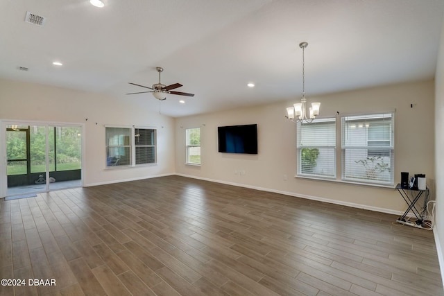 unfurnished living room featuring hardwood / wood-style floors, ceiling fan with notable chandelier, and a healthy amount of sunlight