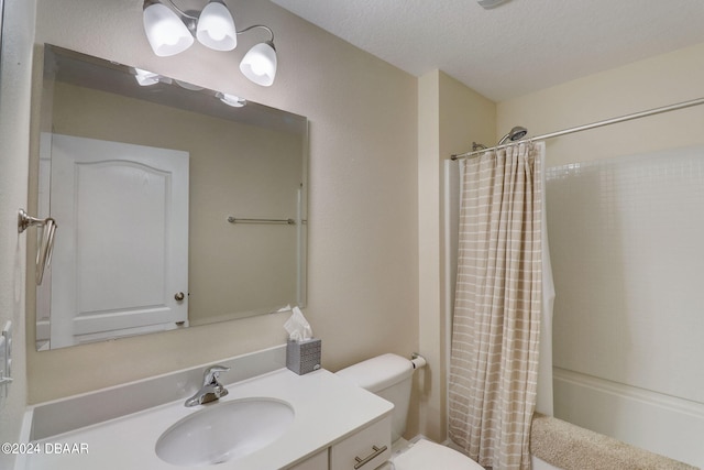 full bathroom featuring vanity, a textured ceiling, shower / bath combo, and toilet