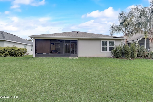 back of house with a sunroom and a yard