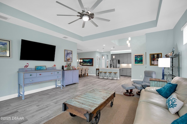 308 Low Tide Ln, Daytona Beach, FL 32124 - living area featuring a raised ceiling, light wood-type flooring, a ceiling fan, and recessed lighting