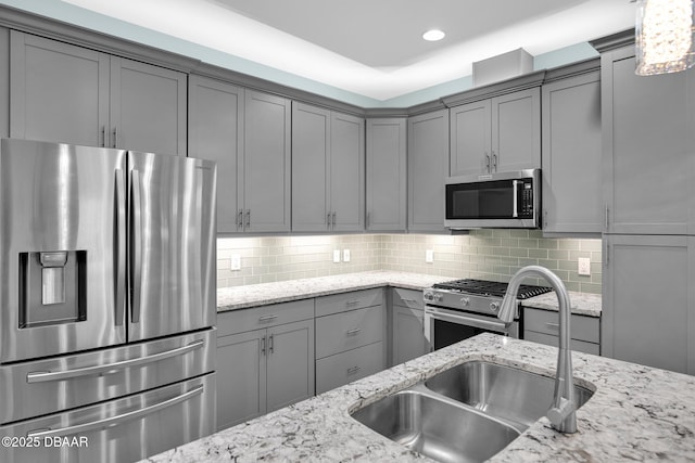 308 Low Tide Ln, Daytona Beach, FL 32124 - kitchen with appliances with stainless steel finishes, gray cabinets, backsplash, light stone countertops, and recessed lighting