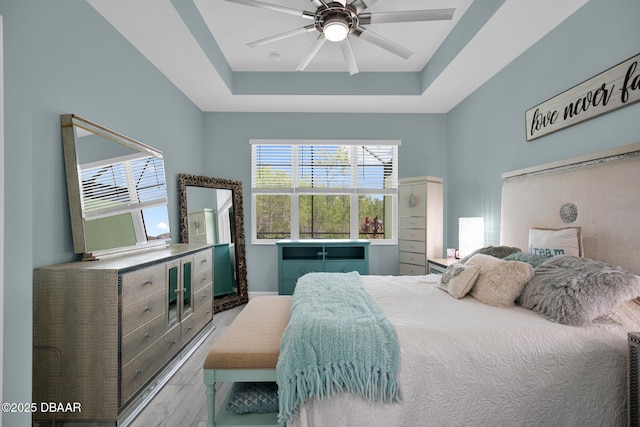 308 Low Tide Ln, Daytona Beach, FL 32124 - bedroom with a raised ceiling, ceiling fan, and wood finished floors