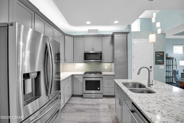 308 Low Tide Ln, Daytona Beach, FL 32124 - kitchen with appliances with stainless steel finishes, gray cabinets, light stone counters, decorative backsplash, and recessed lighting