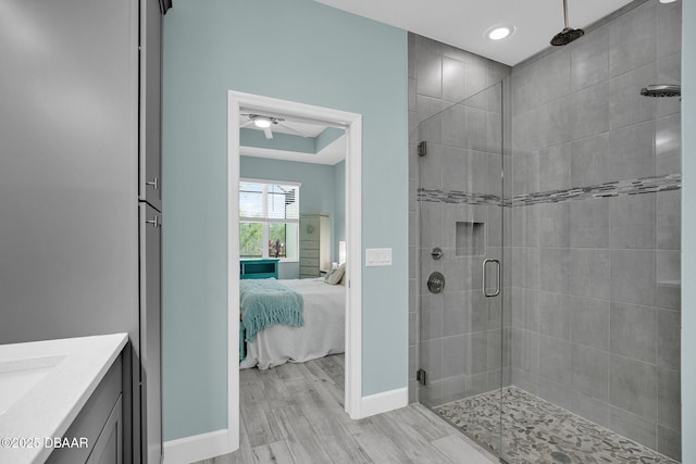 308 Low Tide Ln, Daytona Beach, FL 32124 - full bath with ensuite bath, a shower stall, wood finished floors, vanity, and ceiling fan