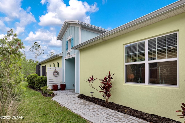 308 Low Tide Ln, Daytona Beach, FL 32124 - property entrance with stucco siding and board and batten siding