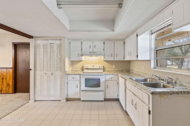 kitchen with sink, white cabinets, light colored carpet, white appliances, and a textured ceiling