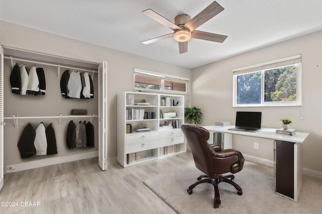 office space with light wood-type flooring and ceiling fan