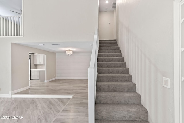 stairs with hardwood / wood-style flooring