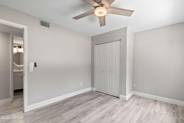 unfurnished bedroom with a closet, light hardwood / wood-style floors, and ceiling fan