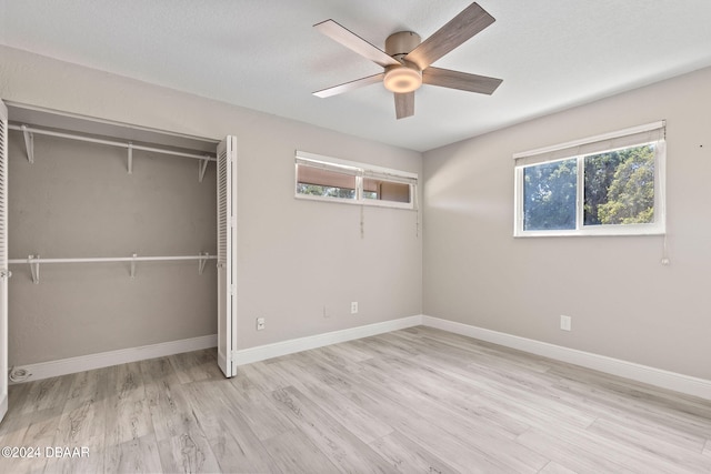 unfurnished bedroom featuring light hardwood / wood-style flooring, ceiling fan, and a closet