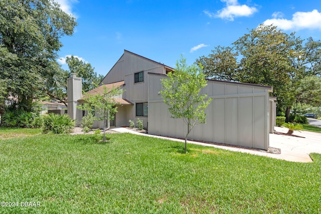 rear view of house with a lawn