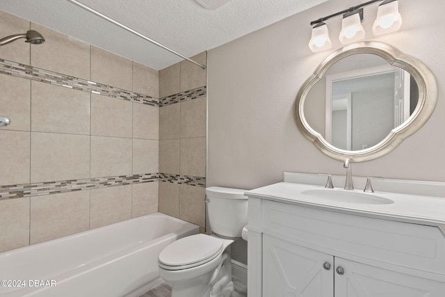 full bathroom featuring tiled shower / bath, a textured ceiling, toilet, and vanity