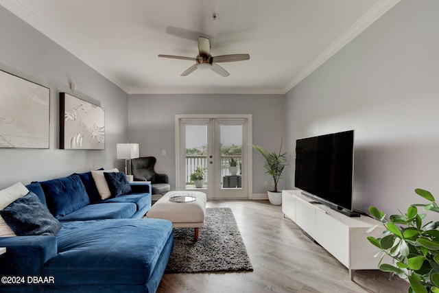 living room with ornamental molding, light wood-type flooring, ceiling fan, and french doors