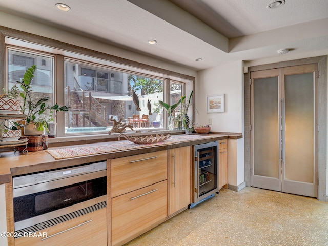 kitchen featuring a textured ceiling and wine cooler