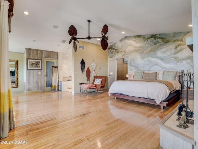 bedroom with vaulted ceiling and light hardwood / wood-style flooring