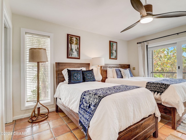 tiled bedroom with multiple windows and ceiling fan