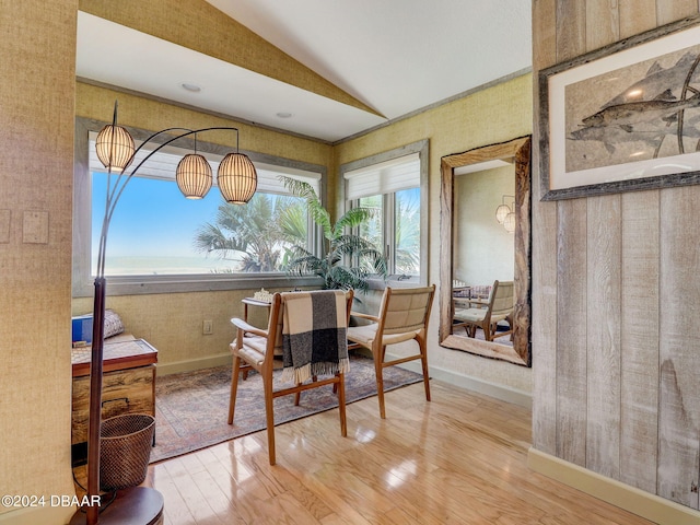 dining space featuring hardwood / wood-style floors and vaulted ceiling