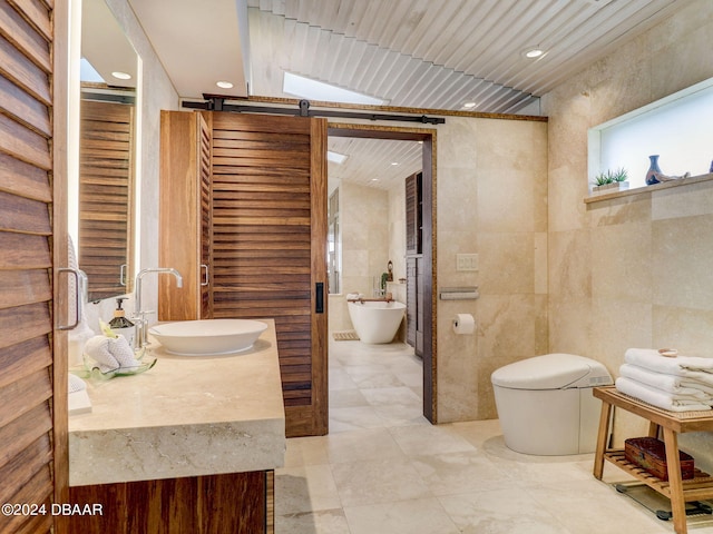 bathroom with toilet, vanity, and tile walls