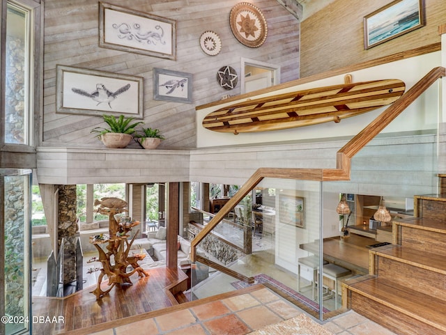 interior space featuring a towering ceiling and wooden walls