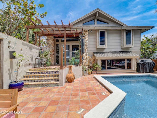 rear view of house with a fenced in pool, a patio, and a pergola