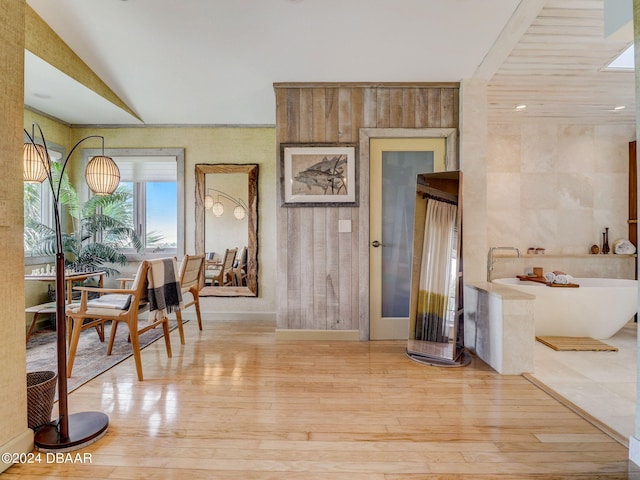 dining area with light wood-type flooring and vaulted ceiling