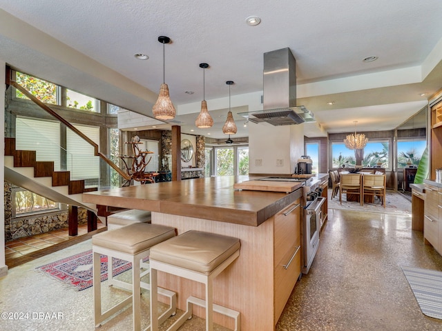 kitchen featuring light brown cabinetry, high end stainless steel range, a textured ceiling, and island exhaust hood