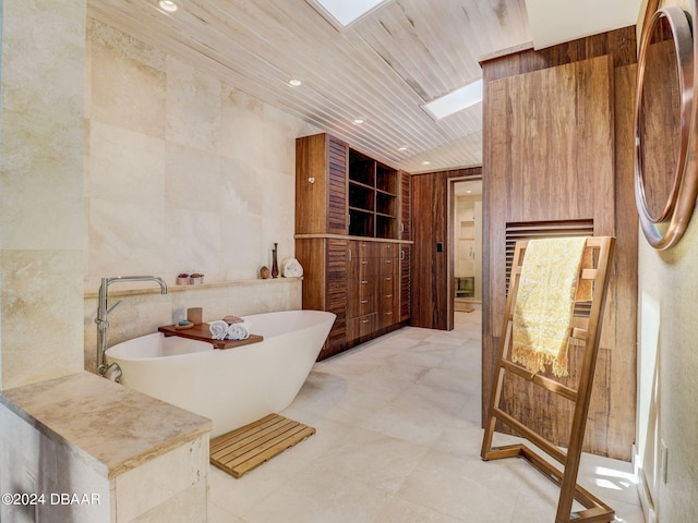 bathroom featuring wooden ceiling, a tub, and tile walls