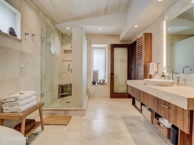 bathroom featuring walk in shower, tile walls, lofted ceiling, and vanity