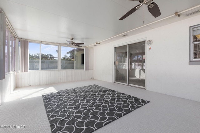 sunroom / solarium featuring ceiling fan