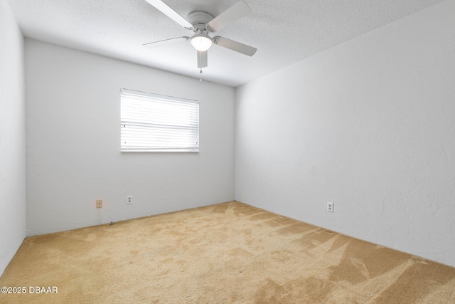 carpeted empty room with a textured ceiling