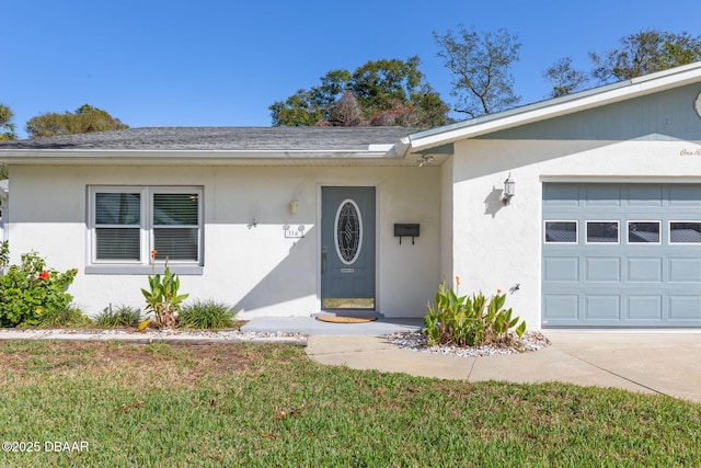 doorway to property with a yard and a garage