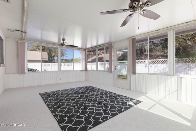 unfurnished sunroom featuring ceiling fan