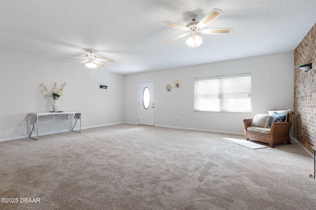 unfurnished room with a textured ceiling, light colored carpet, and ceiling fan